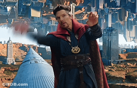 A Man In A Red Cape Is Standing In Front Of A City With Buildings Upside Down GIF