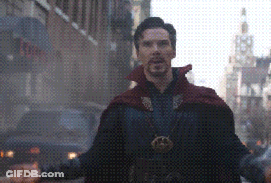 A Man In A Red Cape Stands In Front Of A Building That Says ' Tower ' On It GIF