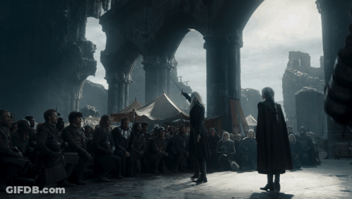 A Man In A Red Cape Stands In Front Of A Crowd GIF