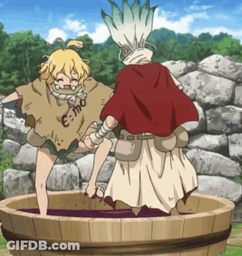 A Man In A Red Cape Stands Next To A Girl In A Barrel With E = Mc2 Written On Her Shirt GIF
