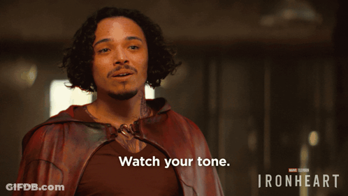 A Man In A Red Cape With The Words Watch Your Tone On The Bottom GIF