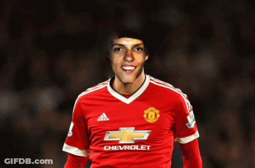 A Man In A Red Chevrolet Jersey Smiles GIF