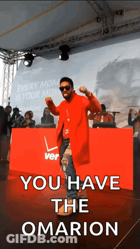 A Man In A Red Coat Is Dancing In Front Of A Sign That Says You Have The Omarion GIF