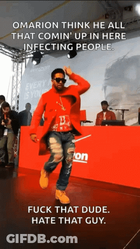 A Man In A Red Coat Is Dancing In Front Of A Verizon Sign GIF