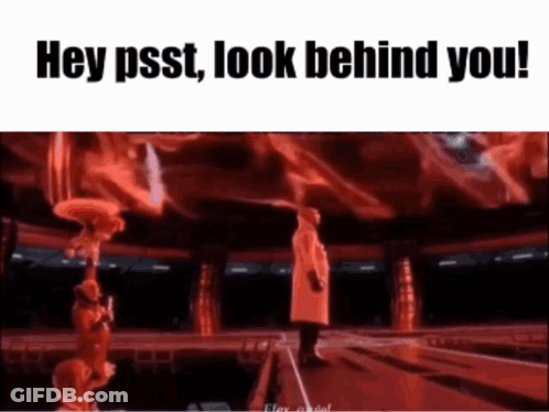 A Man In A Red Coat Is Standing On A Stage In Front Of A Crowd And Says Hey Psst Look Behind You . GIF