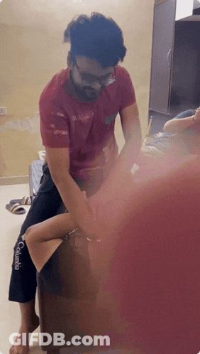 Man In Red Columbia Shirt Sitting On Woman's Knee GIF