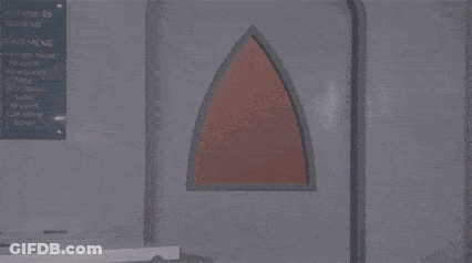 A Man In A Red Devil Costume Is Standing In A Room With The Words Mas E O Daemon Hein . GIF