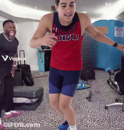 A Man In A Red Dibu Tank Top Is Jumping In The Air GIF