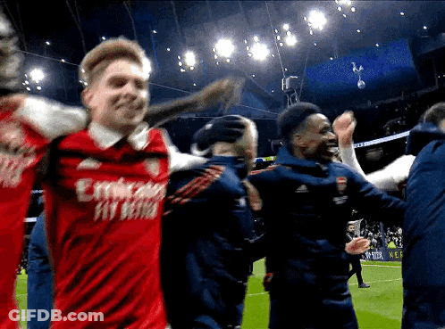 A Man In A Red Emirates Fly Better Jersey Is Being Hugged By Another Man GIF