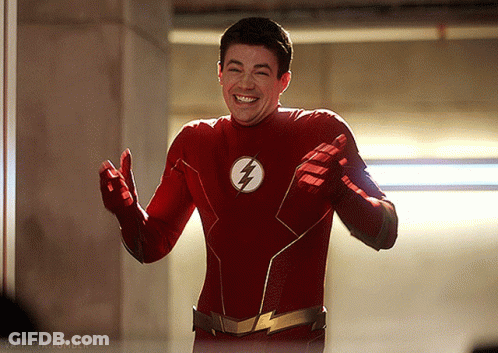 A Man In A Red Flash Costume Is Smiling GIF