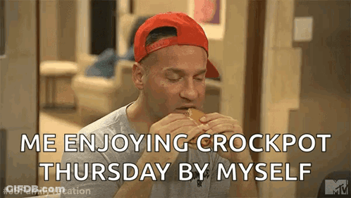 A Man In A Red Hat Is Eating A Hamburger On Thursday By Himself . GIF