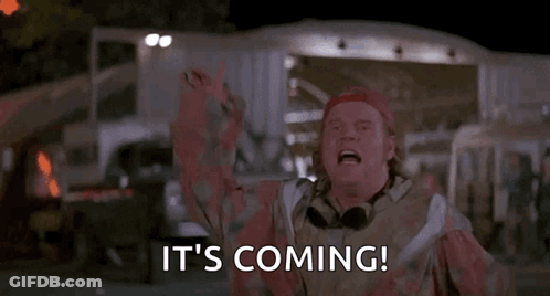 A Man In A Red Hat Is Saying `` It 'S Coming '' With His Arms In The Air . GIF
