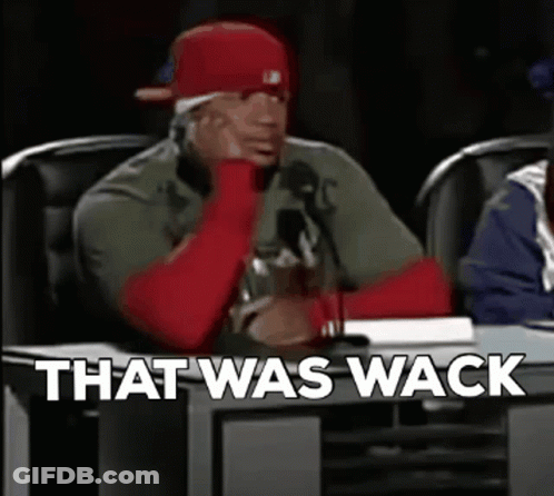 A Man In A Red Hat Is Sitting At A Table With The Words `` That Was Wack '' Written On The Screen . GIF