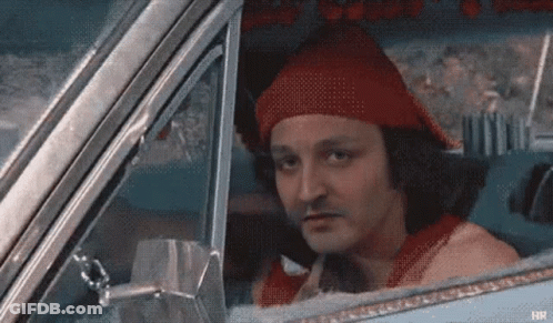A Man In A Red Hat Is Sitting In A Car . GIF
