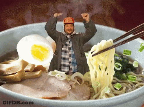 A Man In A Red Hat Is Standing In A Bowl Of Noodles GIF