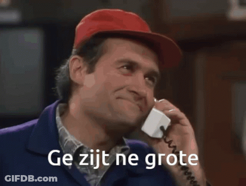 A Man In A Red Hat Is Standing In Front Of A Bar With The Words Ge Zijt Ne Grote Written On The Bottom GIF