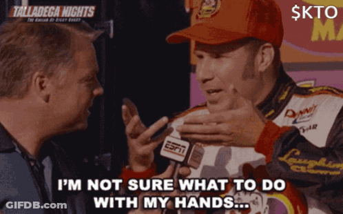 A Man In A Red Hat Is Talking To Another Man While Holding A Espn Microphone GIF