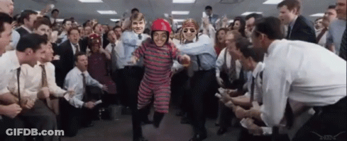 A Man In A Red Helmet Is Surrounded By People GIF