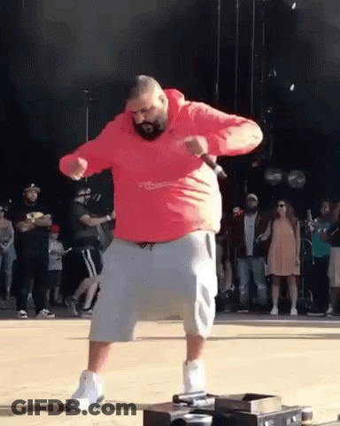 A Man In A Red Hoodie And Shorts Is Dancing On A Stage . GIF