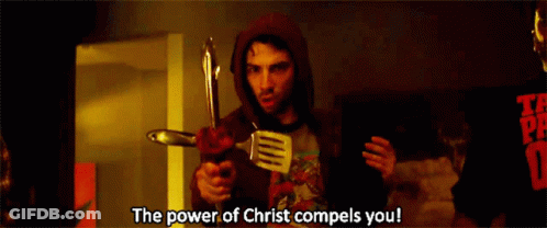 A Man In A Red Hoodie Is Holding A Spatula And A Knife And Says The Power Of Christ Compels You GIF