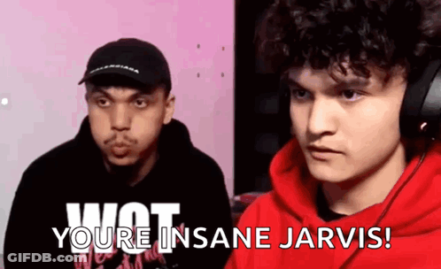 A Man In A Red Hoodie Is Talking To Another Man In A Black Hat While Wearing Headphones . GIF