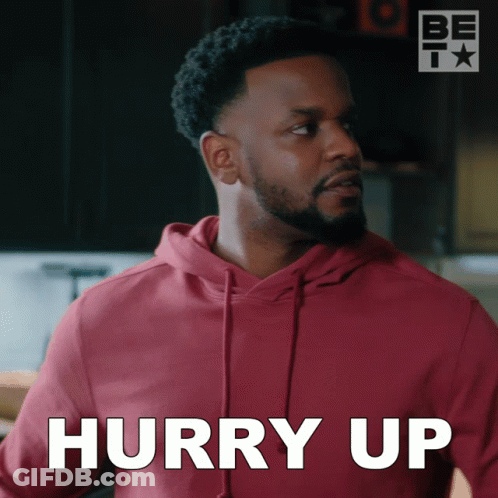 A Man In A Red Hoodie Says Hurry Up In White GIF