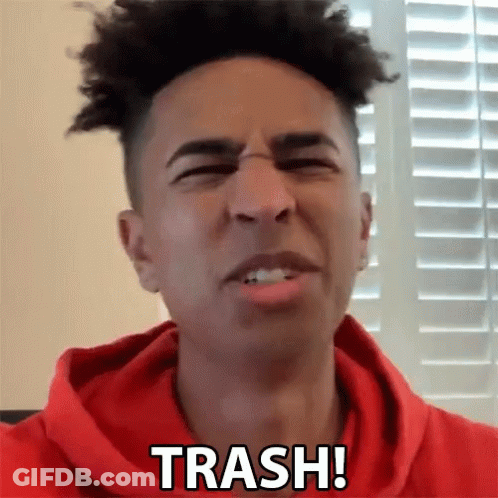 A Man In A Red Hoodie Says Trash In Front Of A Window GIF