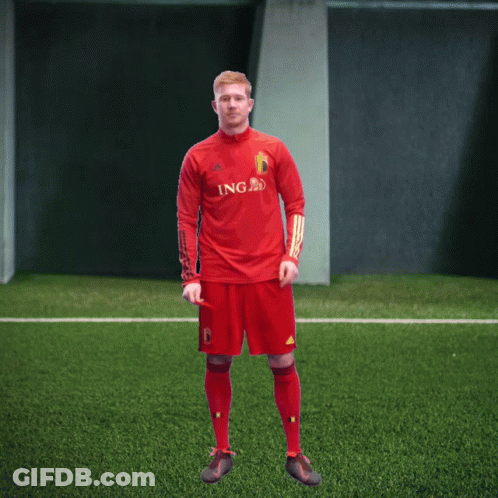 A Man In A Red Ing Jersey Stands On A Green Field GIF