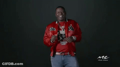 A Man In A Red Jacket And Blue Jeans Is Dancing . GIF