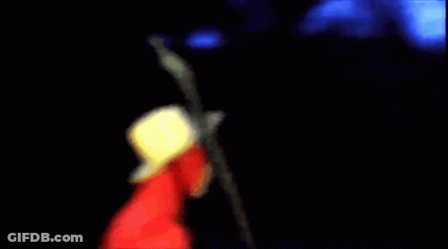 A Man In A Red Jacket And Cowboy Hat Is Holding A Microphone . GIF
