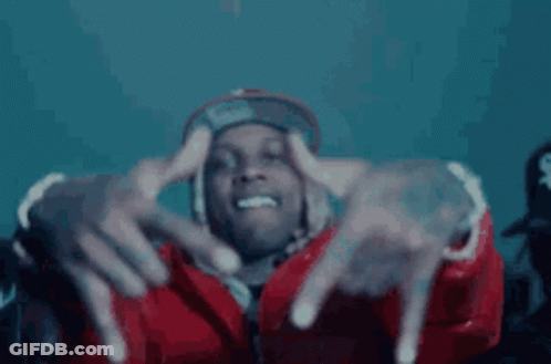 A Man In A Red Jacket And Hat Is Making A Hand Gesture With His Fingers . GIF