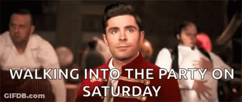 A Man In A Red Jacket And Tie Is Walking Into A Party On Saturday . GIF