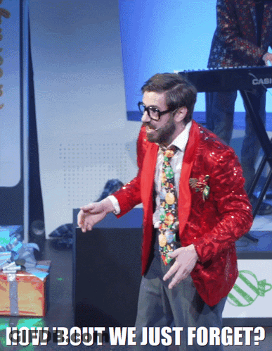 A Man In A Red Jacket And Tie Stands In Front Of A Keyboard That Says Casio On It GIF