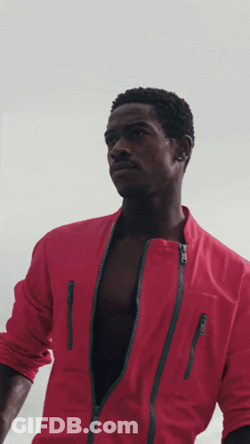 A Man In A Red Jacket Has A Green Zipper GIF