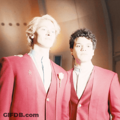 A Man In A Red Jacket Has A Star On His Collar GIF