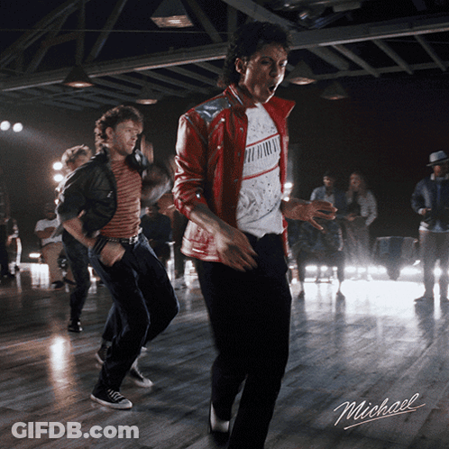 A Man In A Red Jacket Is Dancing In A Room With The Word Michael On The Bottom GIF