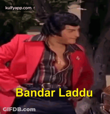 A Man In A Red Jacket Is Dancing With The Words Bandar Laddu Written In Yellow . GIF