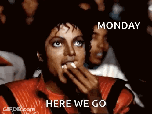 A Man In A Red Jacket Is Eating Popcorn With The Words Monday Here We Go Below Him GIF