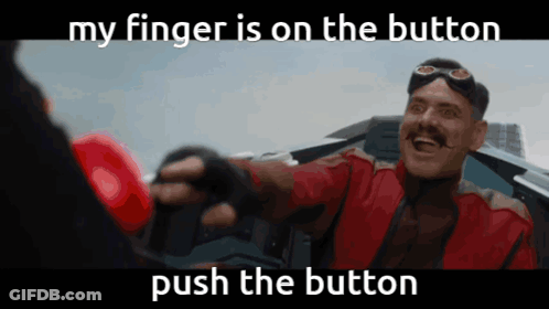 A Man In A Red Jacket Is Holding A Red Boxing Glove And Says " My Finger Is On The Button Push The Button " GIF