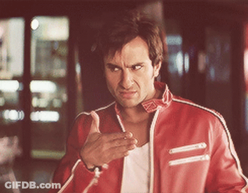 A Man In A Red Jacket Is Making A Funny Face GIF