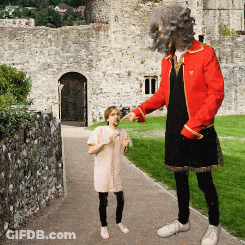 A Man In A Red Jacket Is Pointing At A Little Girl GIF