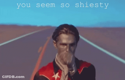A Man In A Red Jacket Is Pointing At The Camera With The Words " You Seem So Shiesty " Below Him GIF