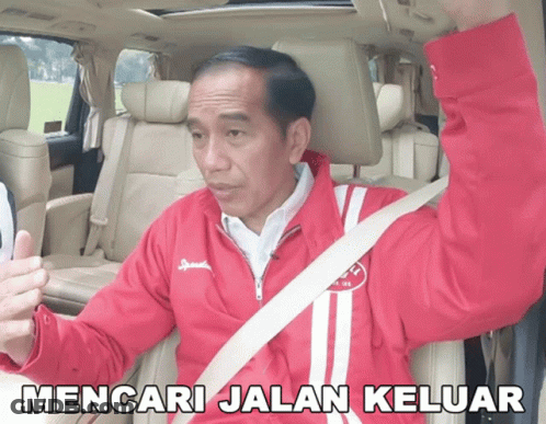 A Man In A Red Jacket Is Sitting In A Car With The Words Mencari Jalan Keluar Written Below Him GIF