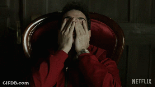 A Man In A Red Jacket Is Sitting In A Chair With Netflix Written In The Corner GIF