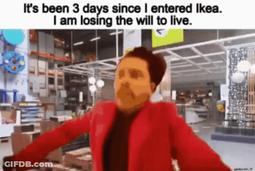 A Man In A Red Jacket Is Standing In An Ikea Store And Losing The Will To Live . GIF