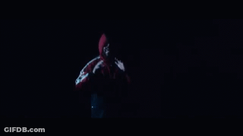 A Man In A Red Jacket Is Standing In Front Of A Group Of Dancers Holding Drums GIF