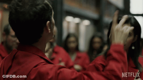 A Man In A Red Jacket Is Standing In Front Of A Group Of People With Netflix Written On The Bottom Of The Screen GIF