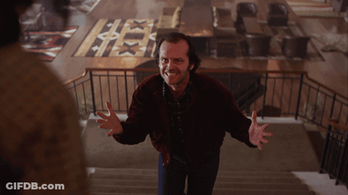 A Man In A Red Jacket Is Standing On A Set Of Stairs With His Arms Outstretched GIF