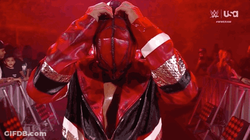 A Man In A Red Jacket Is Taking A Picture Of Himself With A Camera . GIF