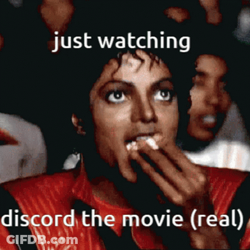 A Man In A Red Jacket Is Watching A Movie And Says Just Watching Discord The Movie ( Real ) GIF
